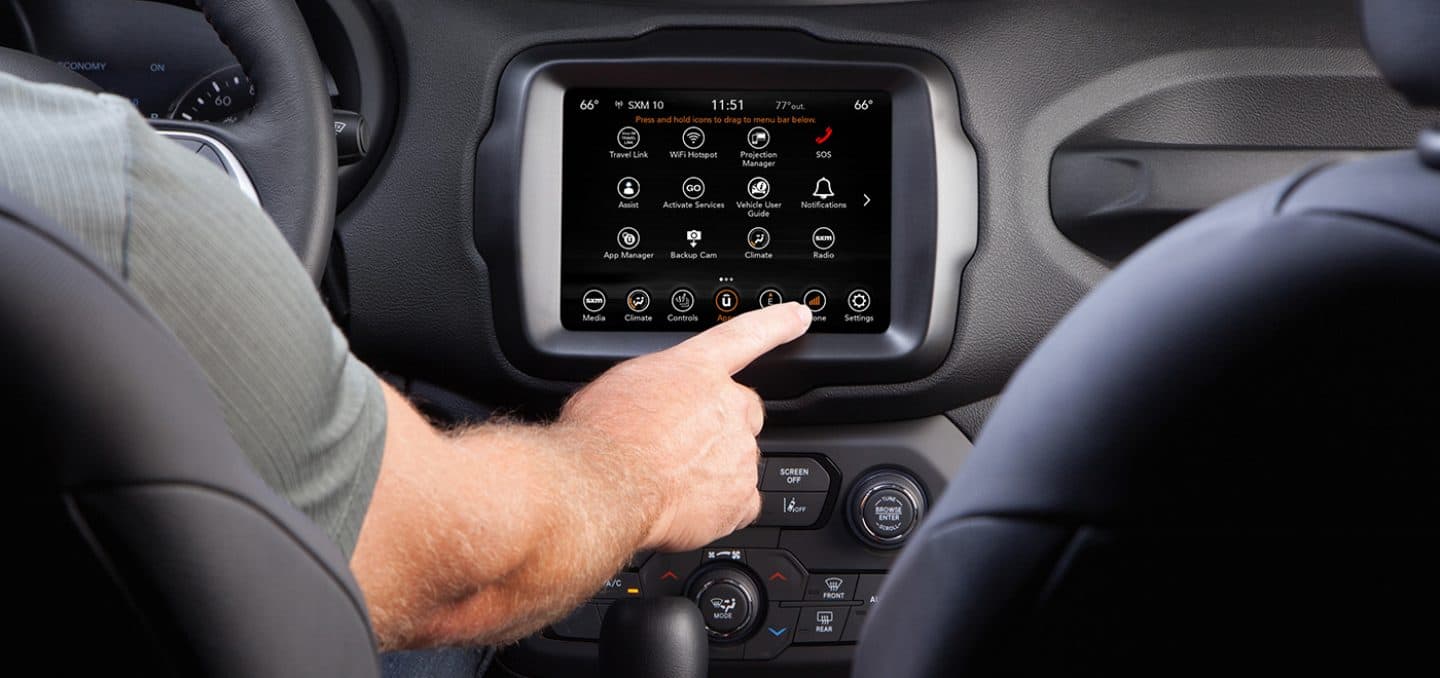 Display A close-up of the Uconnect touchscreen in the 2023 Jeep Renegade as the driver selects the phone button from a variety of icon choices.