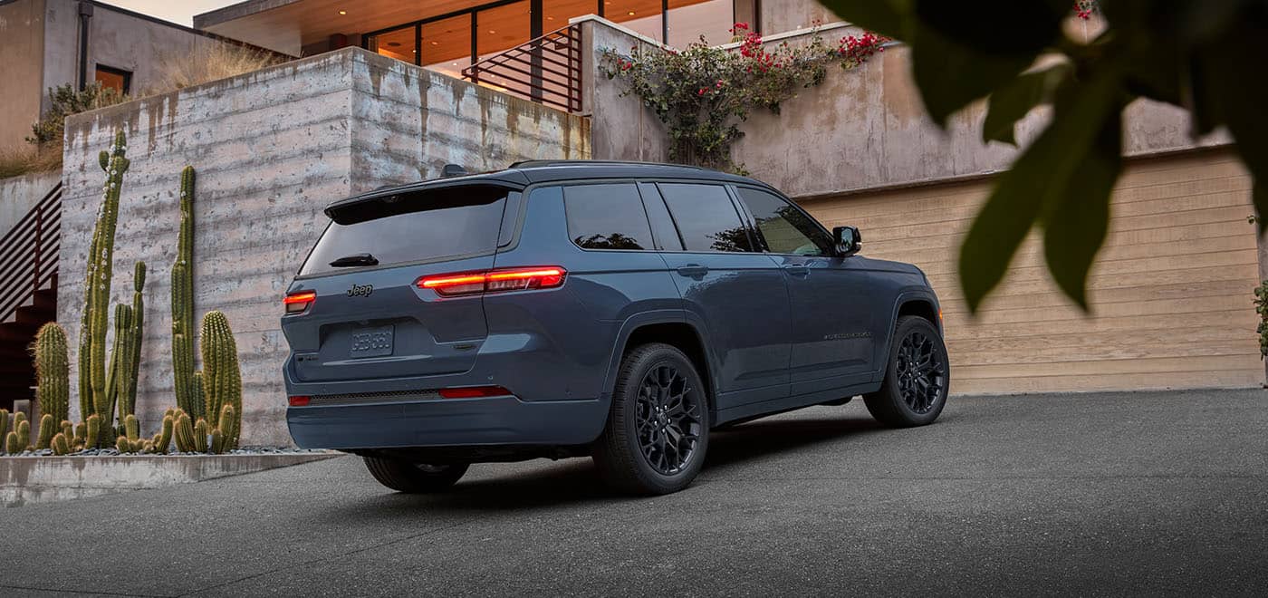 Blue Jeep Grand Cherokee L, rear three-quarter view