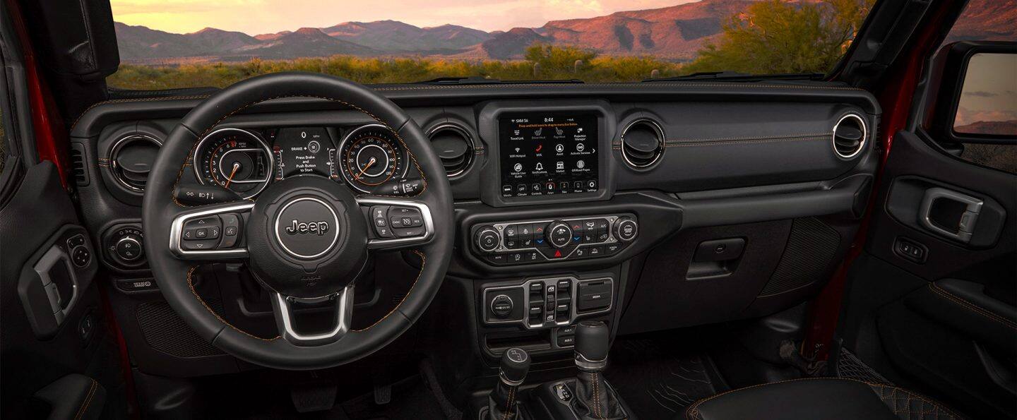 The interior of the 2021 Jeep Gladiator Overland, focusing on the steering wheel and instrument panel.