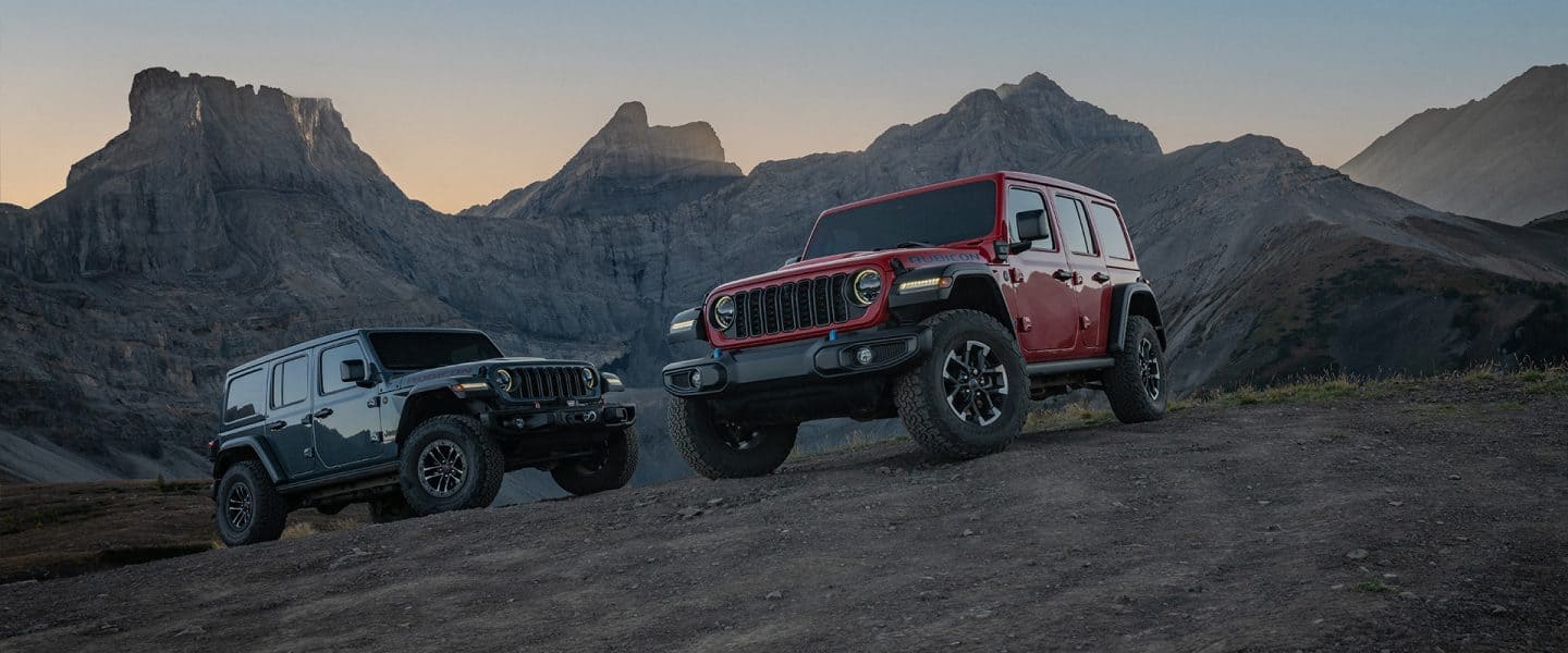 A 2021 Jeep Wrangler Sahara being driven on a busy city street.