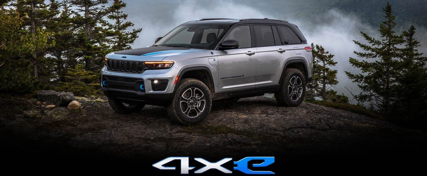 The 2023 Jeep Grand Cherokee 4xe parked atop a boulder.
