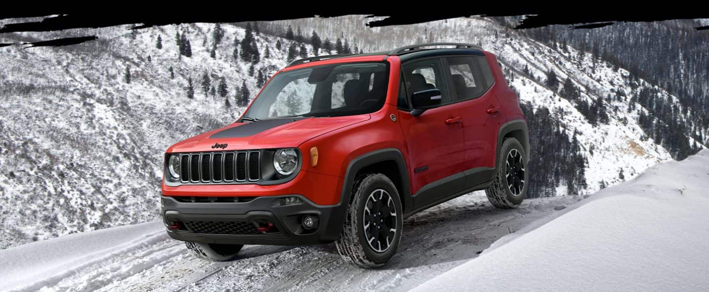 The 2023 Jeep Renegade Trailhawk being driven on snow in the mountains.