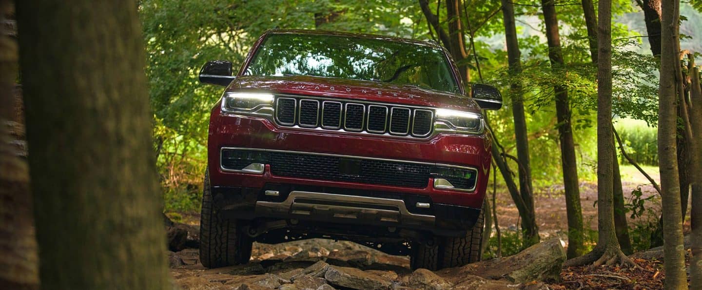 A head-on view of the 2023 Wagoneer Series III being driven in the woods.