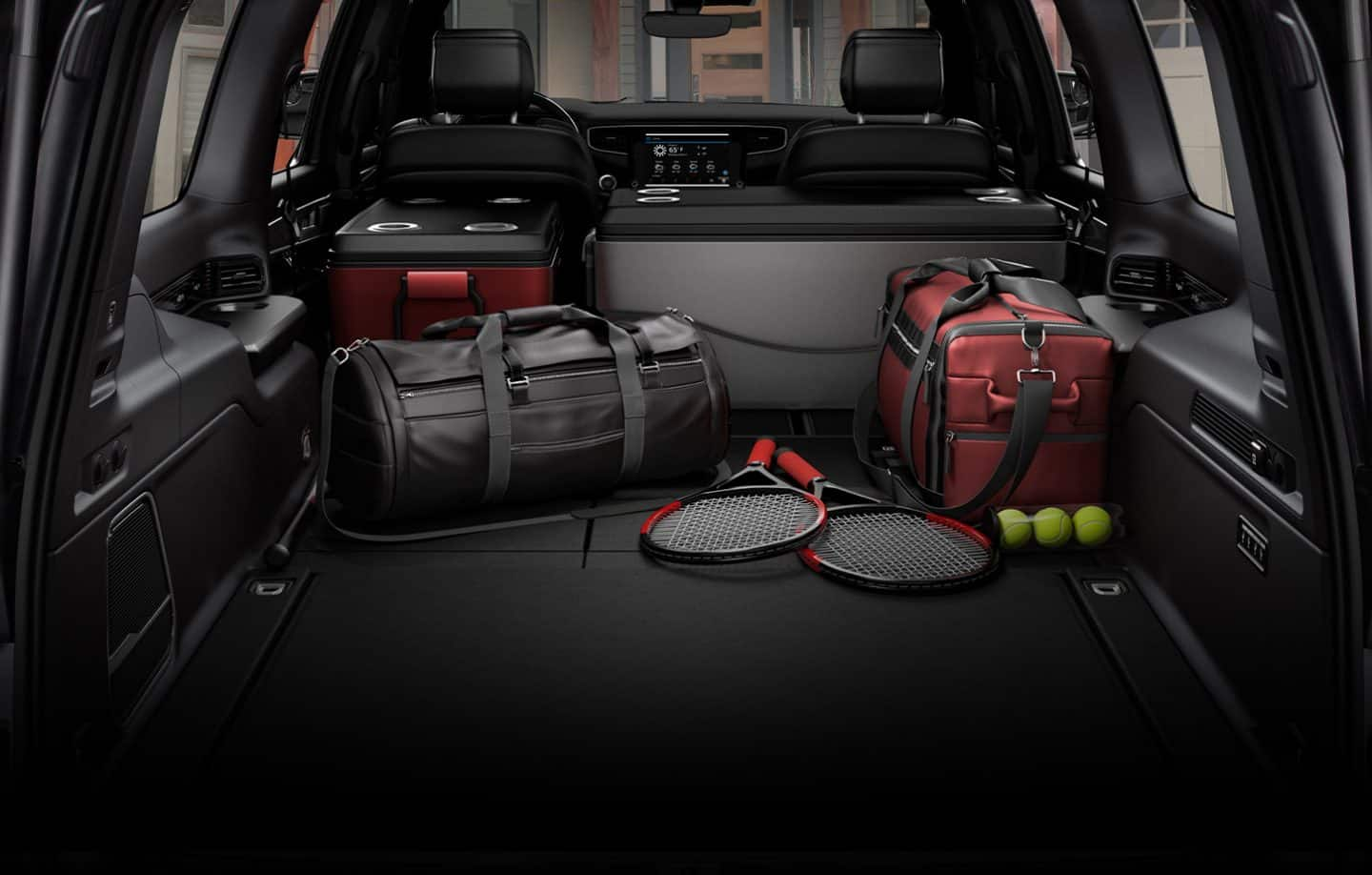 The cargo area of the 2023 Wagoneer with all the rear seats folded to fit coolers, duffel bags and tennis rackets.