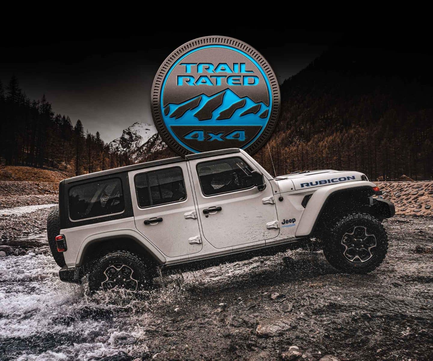 Trail Rated 4x4. The 2023 Jeep Wrangler Rubicon 4xe being driven out of a river and up the bank.