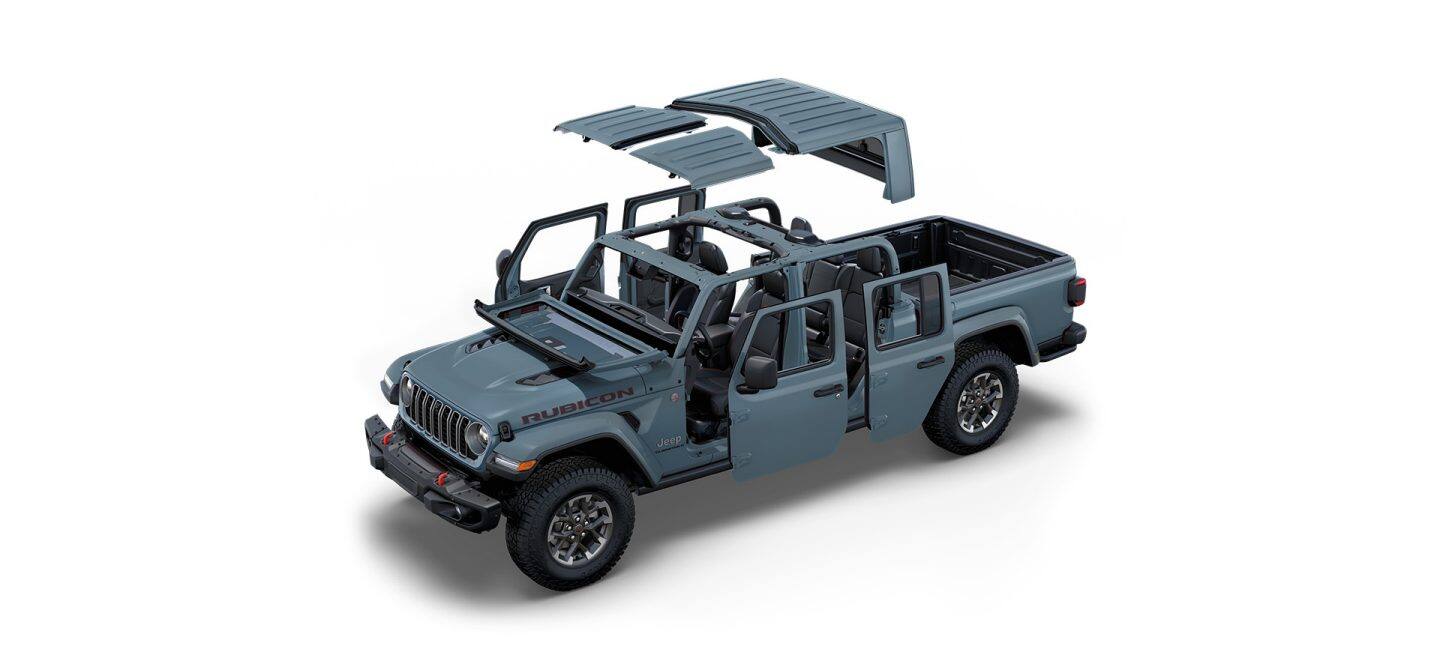 Un Jeep Gladiator Rubicon X gris de 2025 con el techo y las puertas desmontados y el parabrisas plegado.