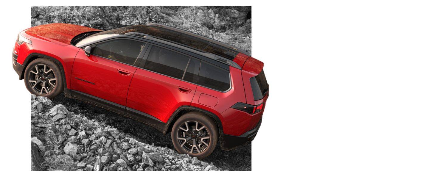 A driver-side profile of a red 2026 Jeep Cherokee Overland.