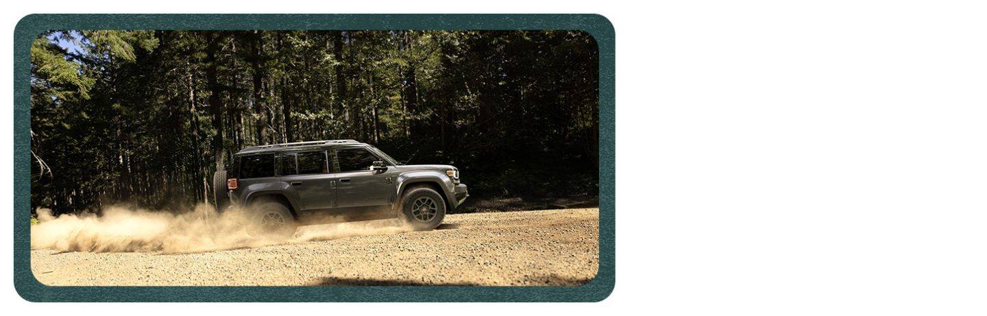 A profile of a gray 2026 Jeep Recon Moab traveling on a trail off-road.