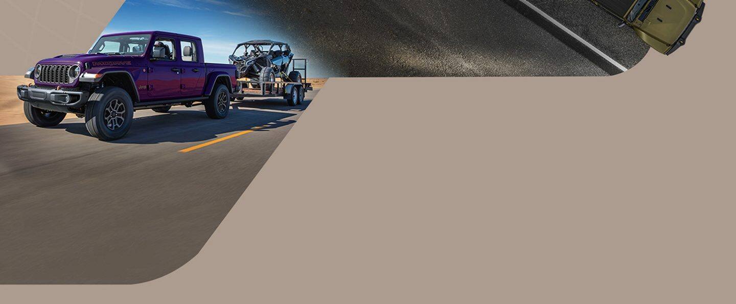 A purple 2026 Jeep Gladiator Mojave X traveling down a highway, towing a dune buggy.