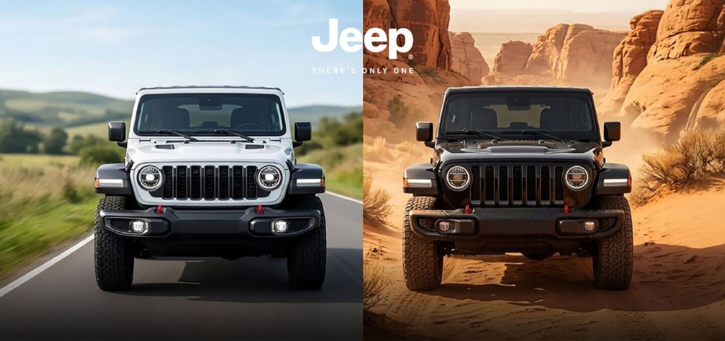 A 2024 Jeep Wrangler Rubicon 4xe with its doors and roof removed, being driven on a sandy trail off-road, with huge boulders on both sides.