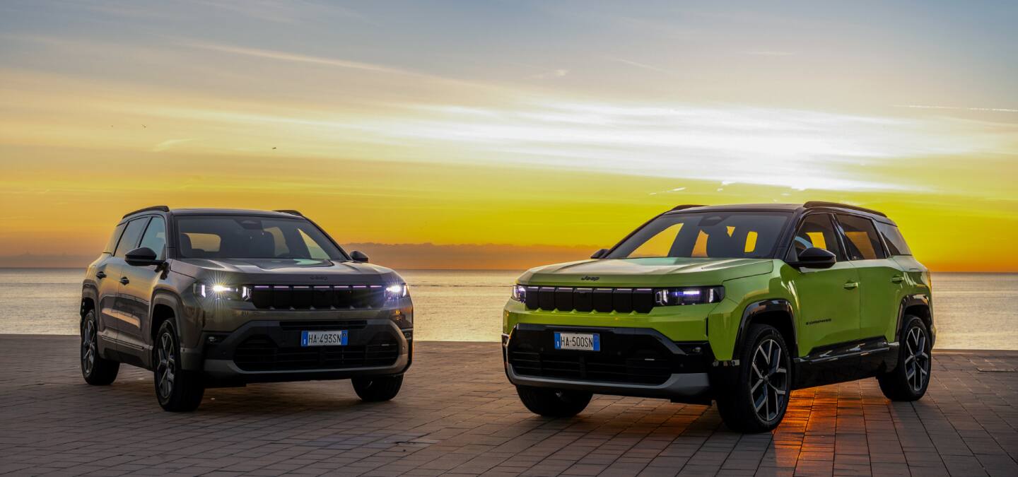 A grouping of seven Jeep Concept vehicles parked randomly in the desert.