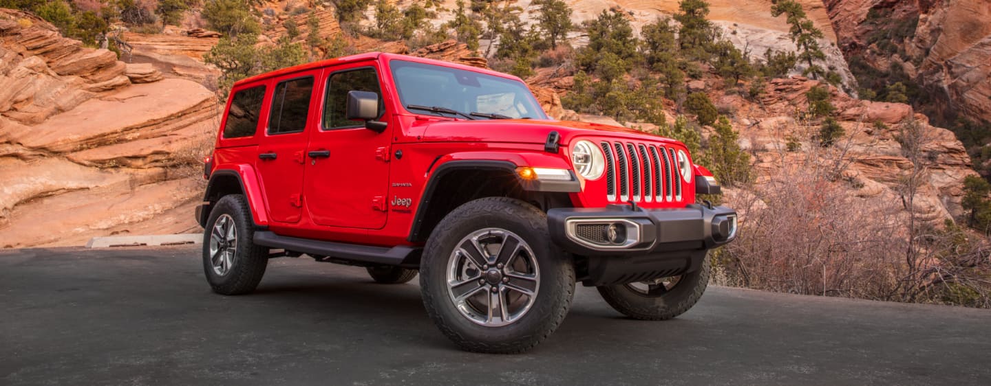 The 2023 Jeep Wrangler Overland being driven over a bridge.