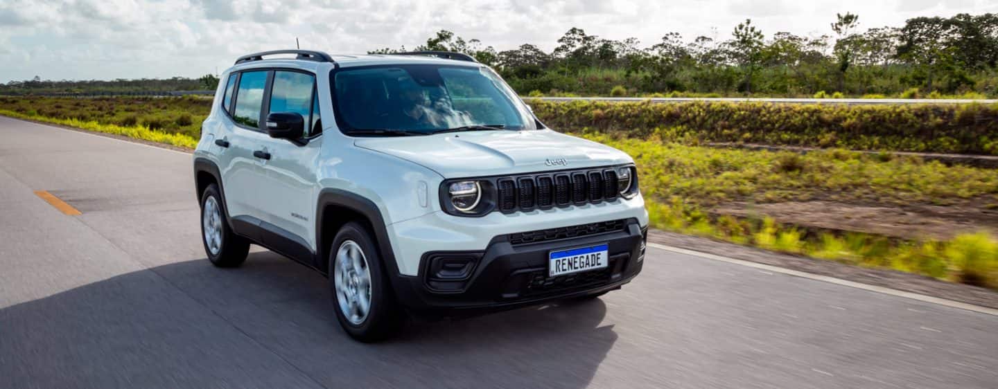 The 2023 Jeep Renegade Trailhawk being driven over a bridge with a kayak and a mountain bike secured to its roof rack.