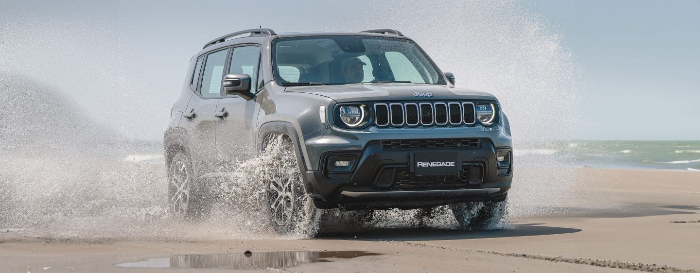 The 2023 Jeep Renegade Trailhawk being driven on snow in the mountains.