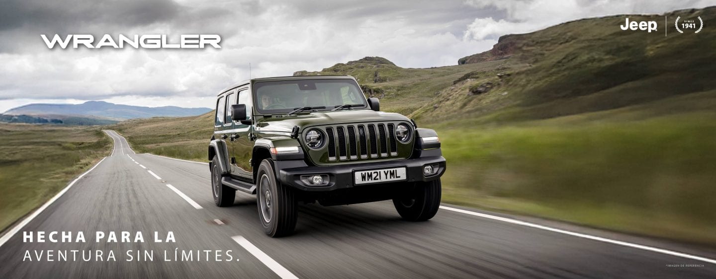 A red 2023 Jeep Wrangler Rubicon 4xe with its roof and doors removed, being driven down a steep hill off-road. Wrangler.