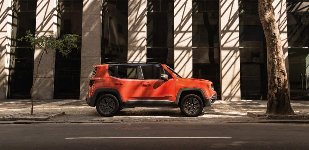 Orange 2018 Jeep Renegade on city street