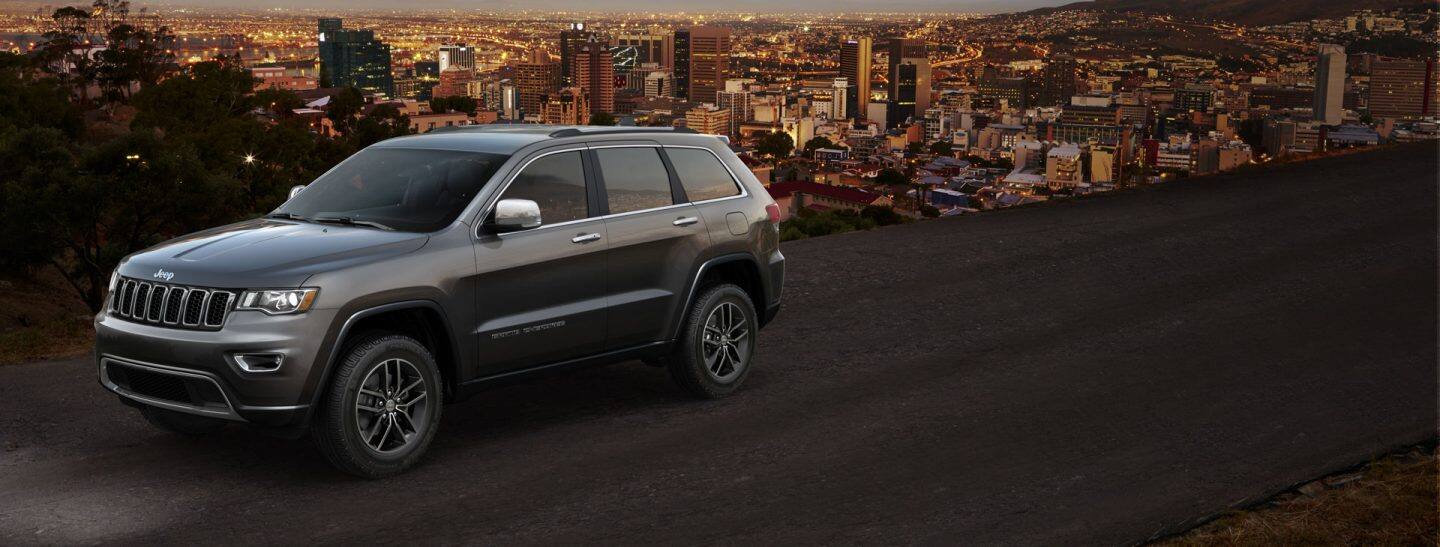 2019-Jeep-Grand-Cherokee-Overview-Hero-Limited-Dusk. AppleExperience_Logo_lockup_233x41