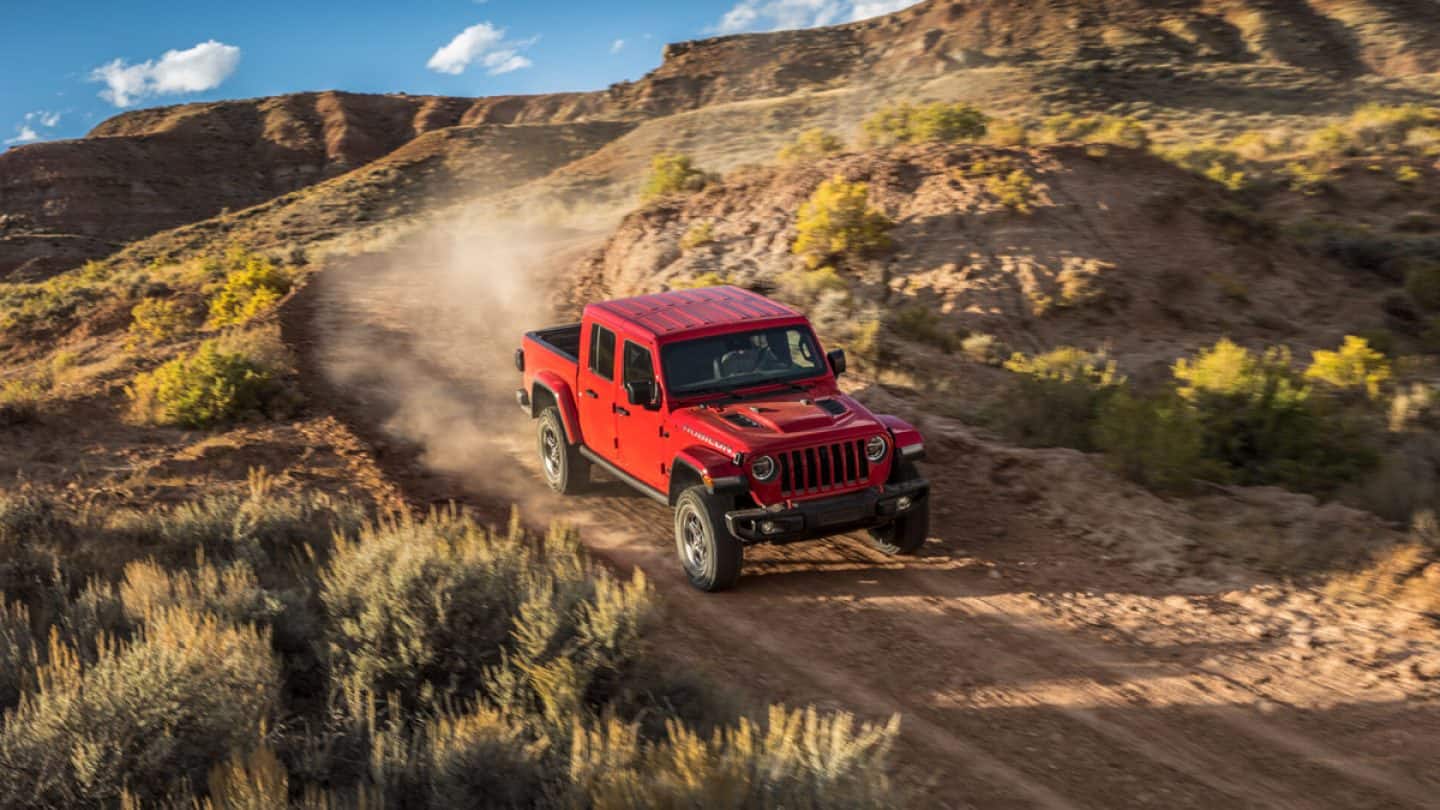 Gladiator driving fast down a descending dirt path