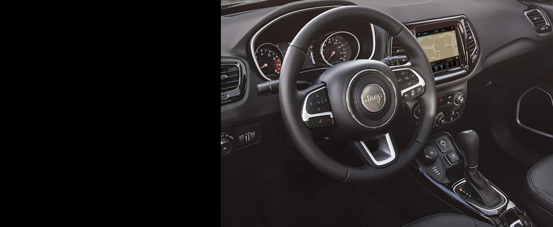 A closeup of the steering wheel in 2021 Jeep Compass