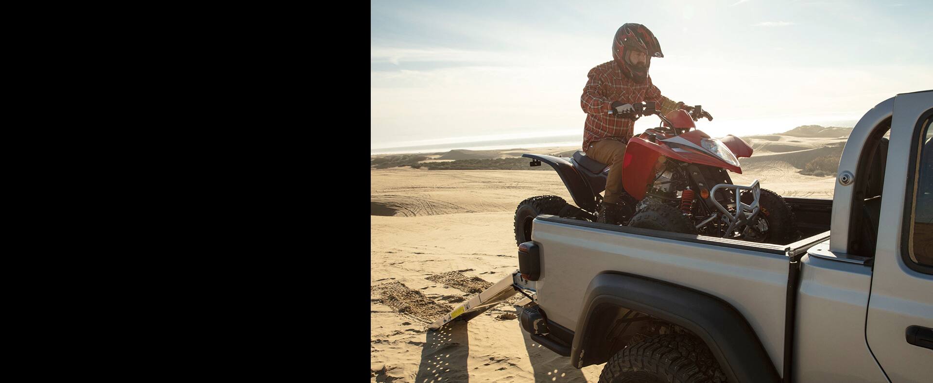 The bed of the 2021 Jeep Gladiator with a dirt bike on board.