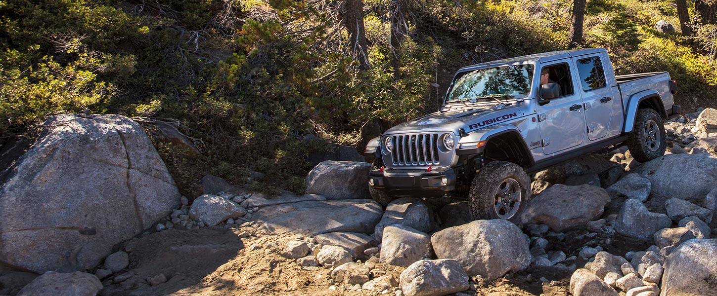 A 2021 Jeep Gladiator Rubicon being driven down a shallow rocky slope.
