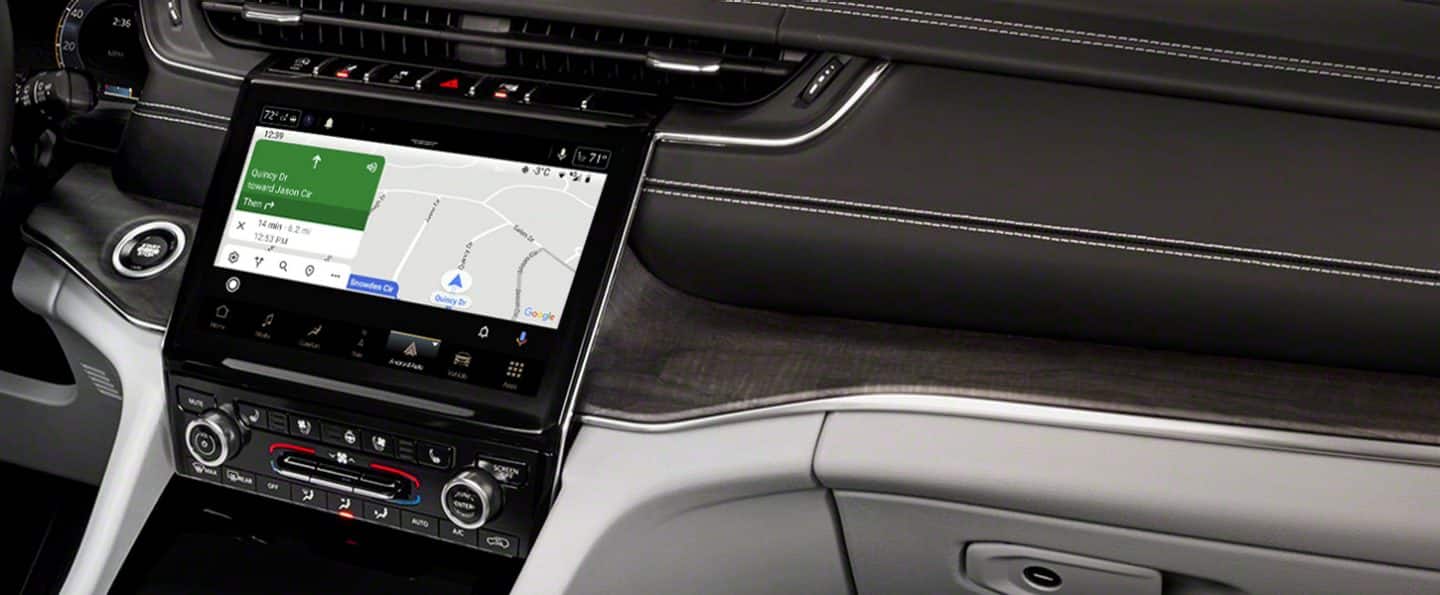 A close-up of the Uconnect touchscreen on the 2021 Jeep Grand Cherokee L, displaying a Navigation map and directions.