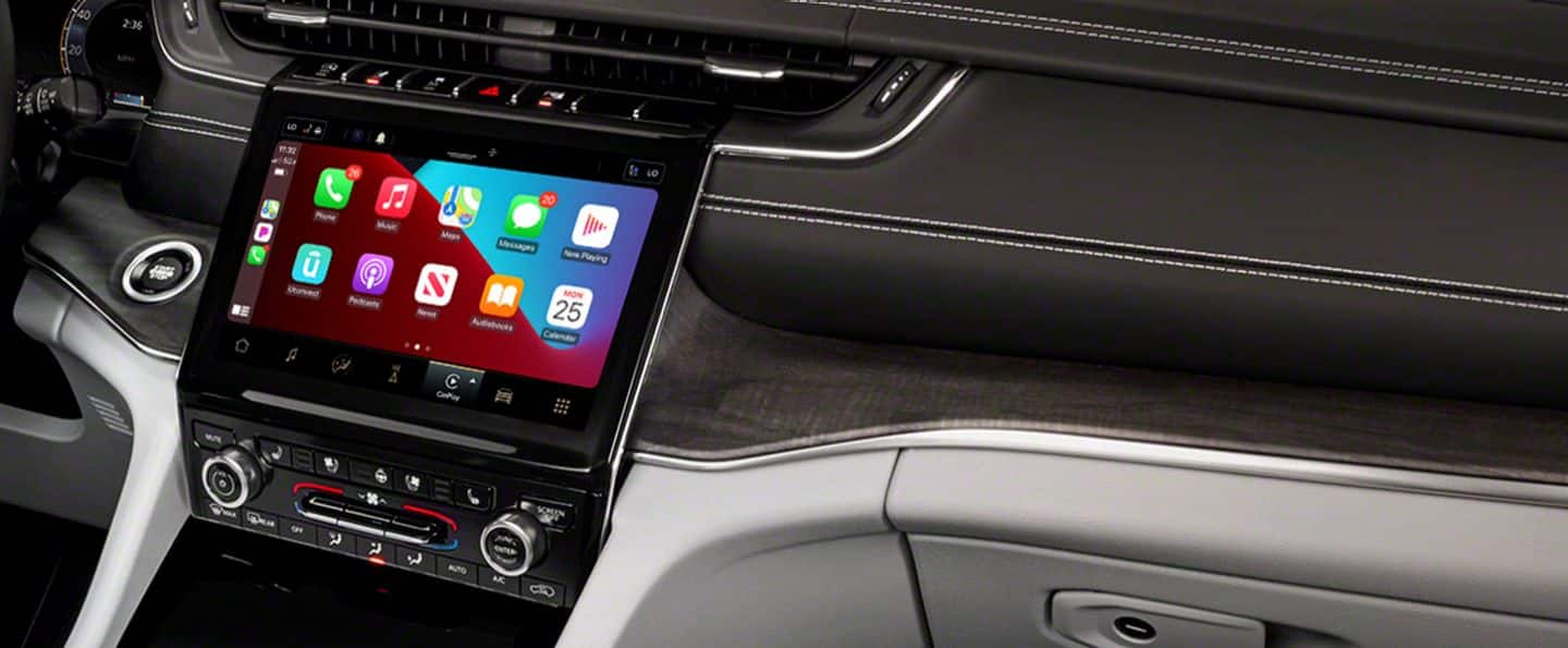 A close-up of the touchscreen in the 2021 Jeep Grand Cherokee L Overland displaying smartphone integration capabilities are engaged.