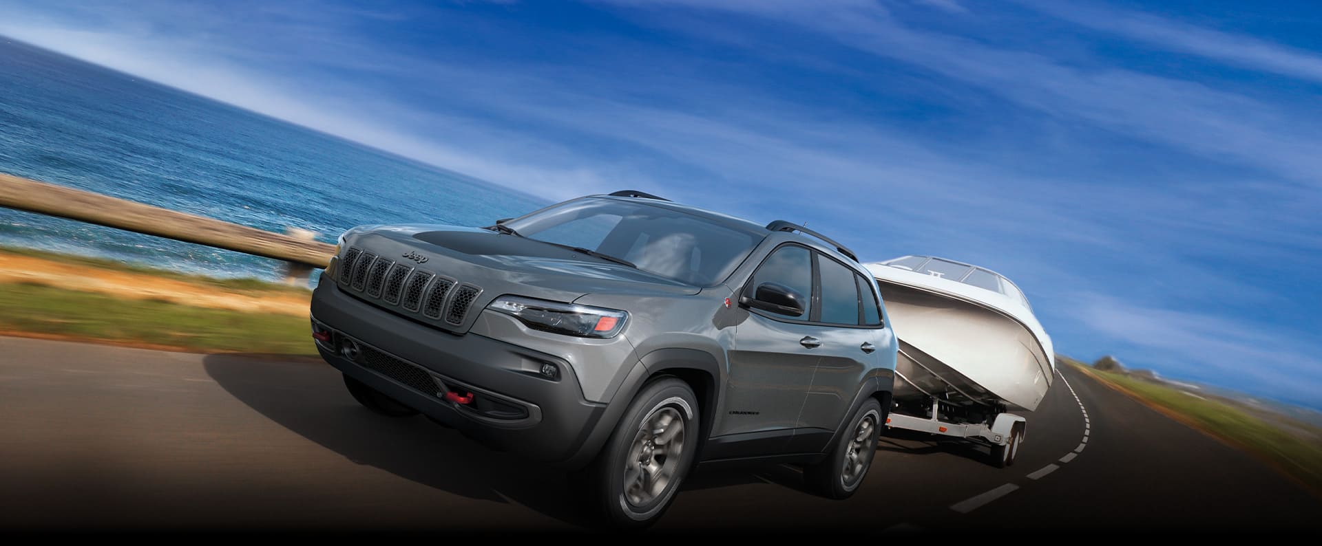 The 2022 Jeep Cherokee Limited towing a boat.