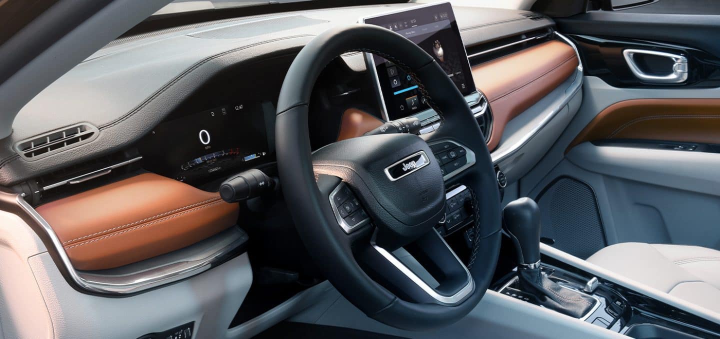 The steering wheel and instrument panel in the 2022 Jeep Compass.