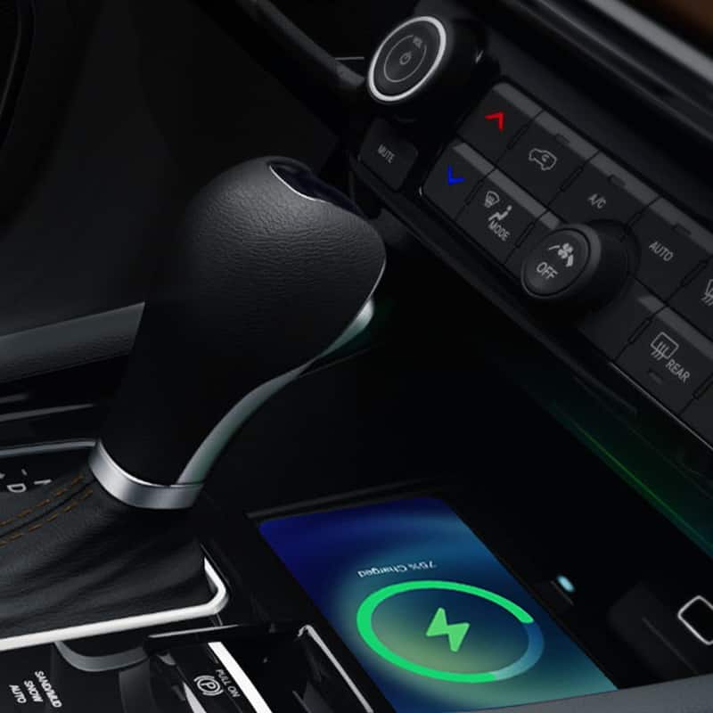 A close-up of a smartphone in the wireless charging pad in the 2022 Jeep Compass.