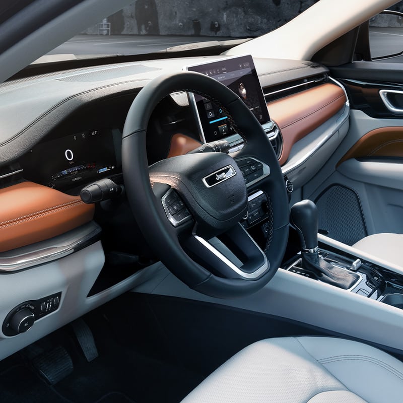 A close-up of the steering wheel in the 2022 Jeep Compass.