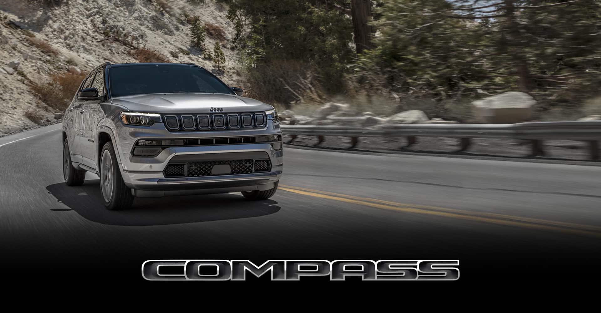 The 2022 Jeep Compass High Altitude being driven on a mountain road with the background blurred to indicate the vehicle's speed.