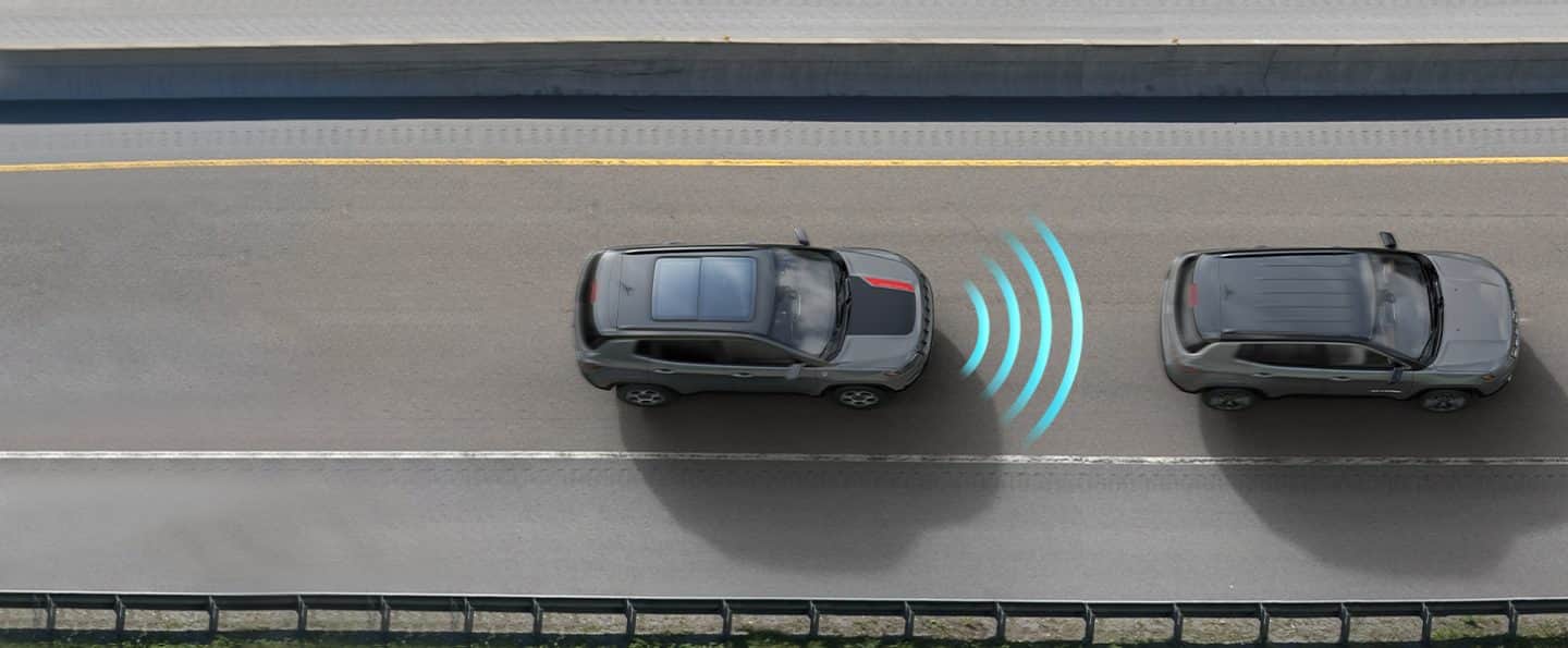 The 2022 Jeep Compass Trailhawk with illustrated sensor bars coming from its front as it approaches a vehicle ahead of it.