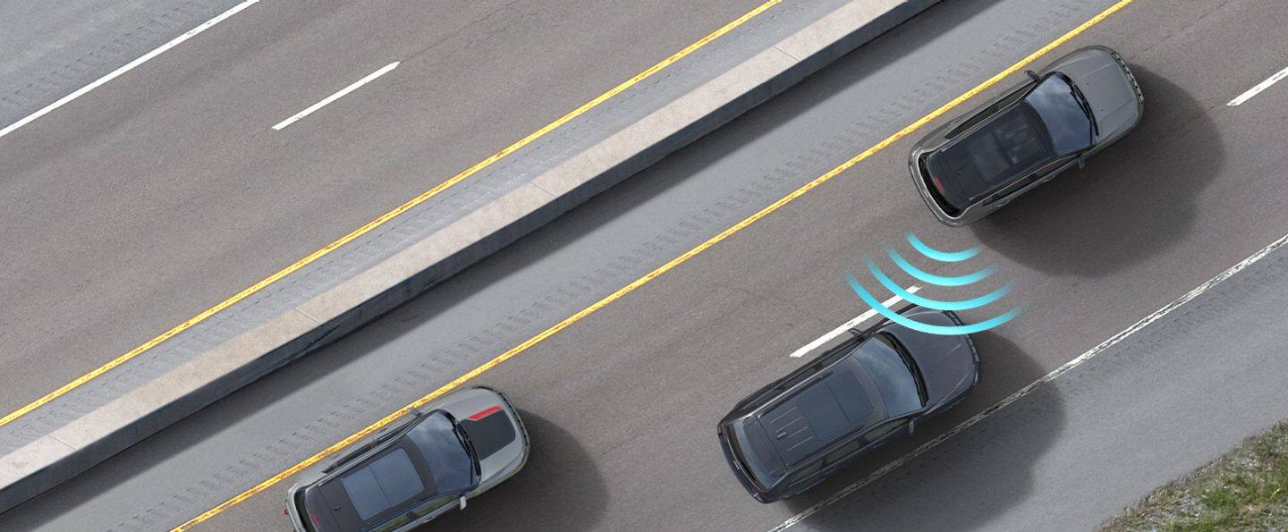 The 2022 Jeep Compass Limited with illustrated sensor bars coming from the rear passenger side of the vehicle, detecting an approaching vehicle in the next lane.