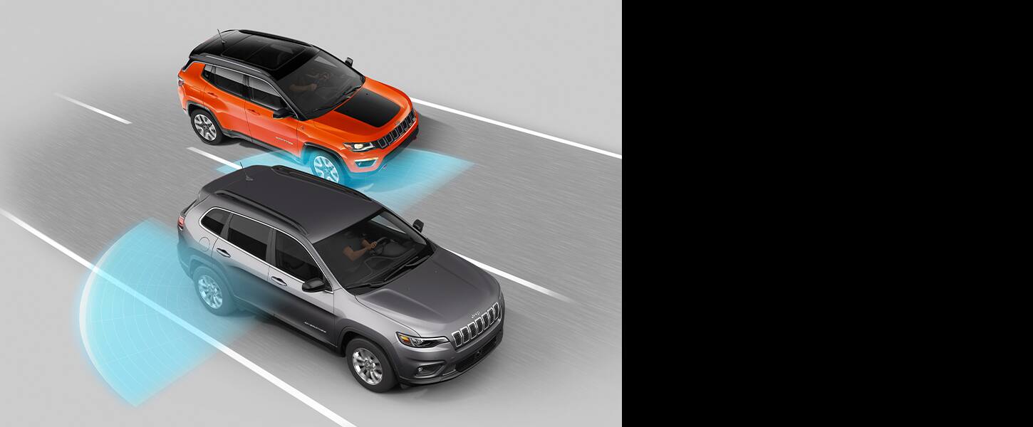 The 2022 Jeep Cherokee with sensor beams emanating from its rear end and extending into the lanes on either side of it.