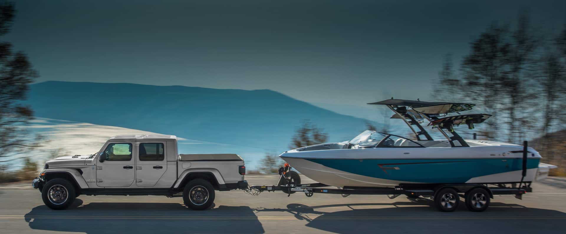 The 2022 Jeep Gladiator Overland towing a motorboat.