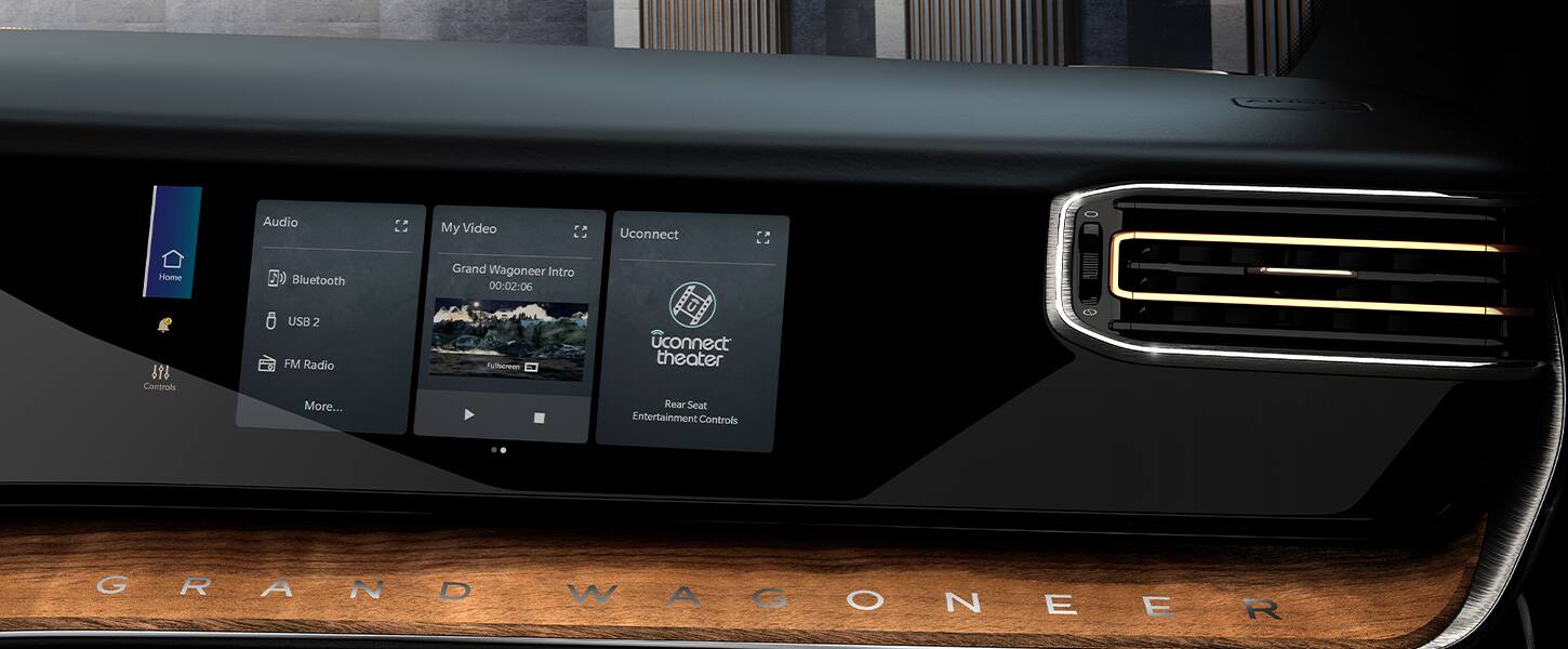 The passenger interactive display in the 2022 Grand Wagoneer Series III with three windows displayed showing audio options, video options and Uconnect theater options.