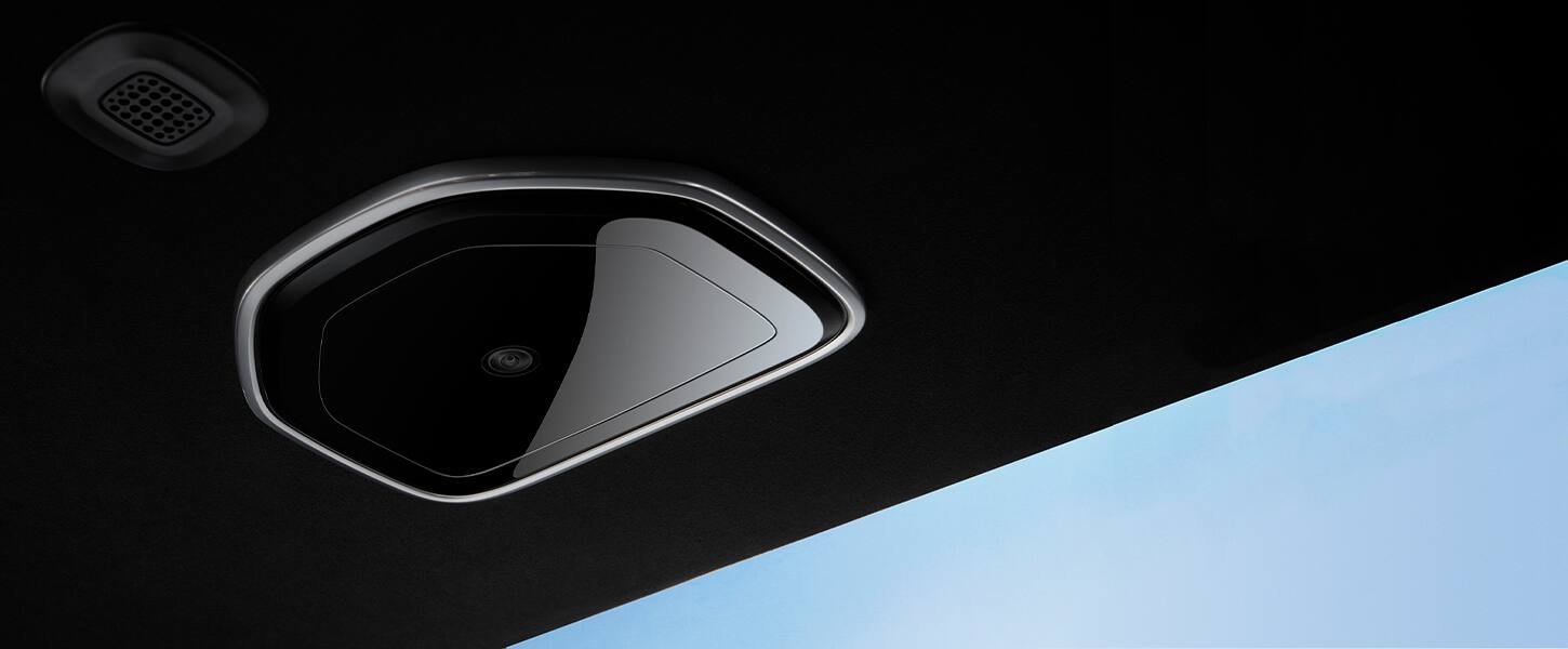 A close-up of the rear monitoring camera in the 2022 Grand Wagoneer, showing the location of the camera on the vehicle ceiling.