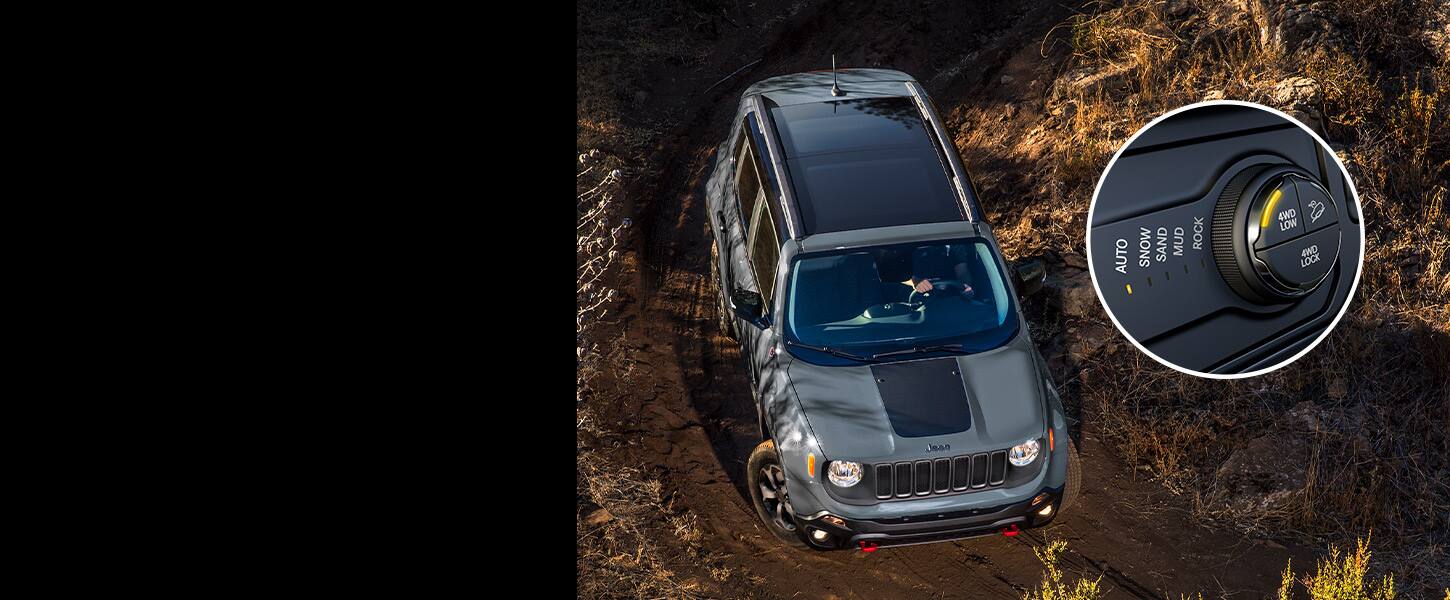 The 2022 Jeep Renegade Trailhawk being driven downhill on a steep dirt trail, along with a close-up insert of the Selec-Terrain Traction Management system knob set to “4WD Low, Auto”