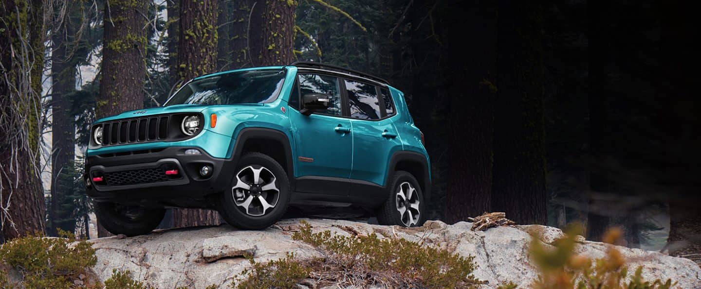 The 2022 Jeep Renegade Trailhawk parked atop a boulder.