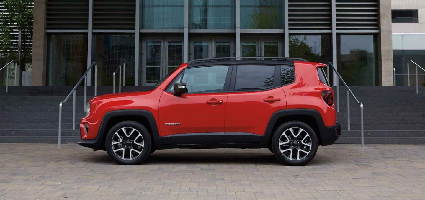 Display The sleek side profile of the 2022 Jeep Renegade Limited, parked in front of steps leading up to an office building.