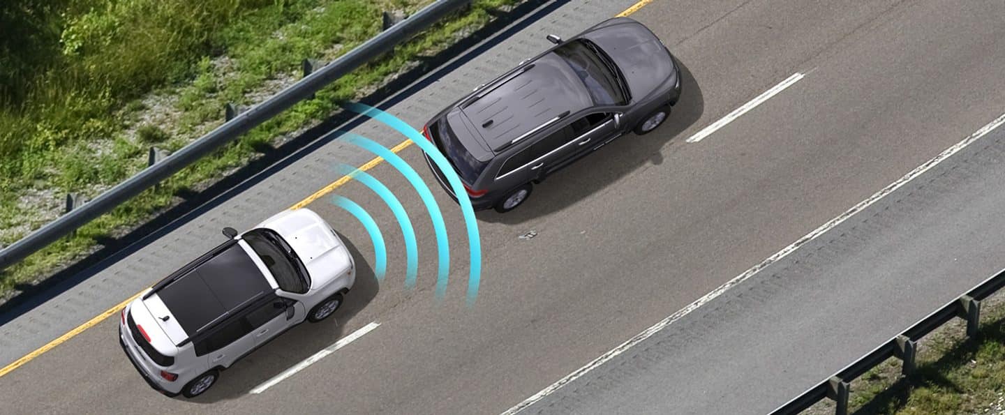 A bird's eye view of the 2022 Jeep Renegade with illustrated sensor bars coming from its front, measuring the distance to the vehicle ahead.
