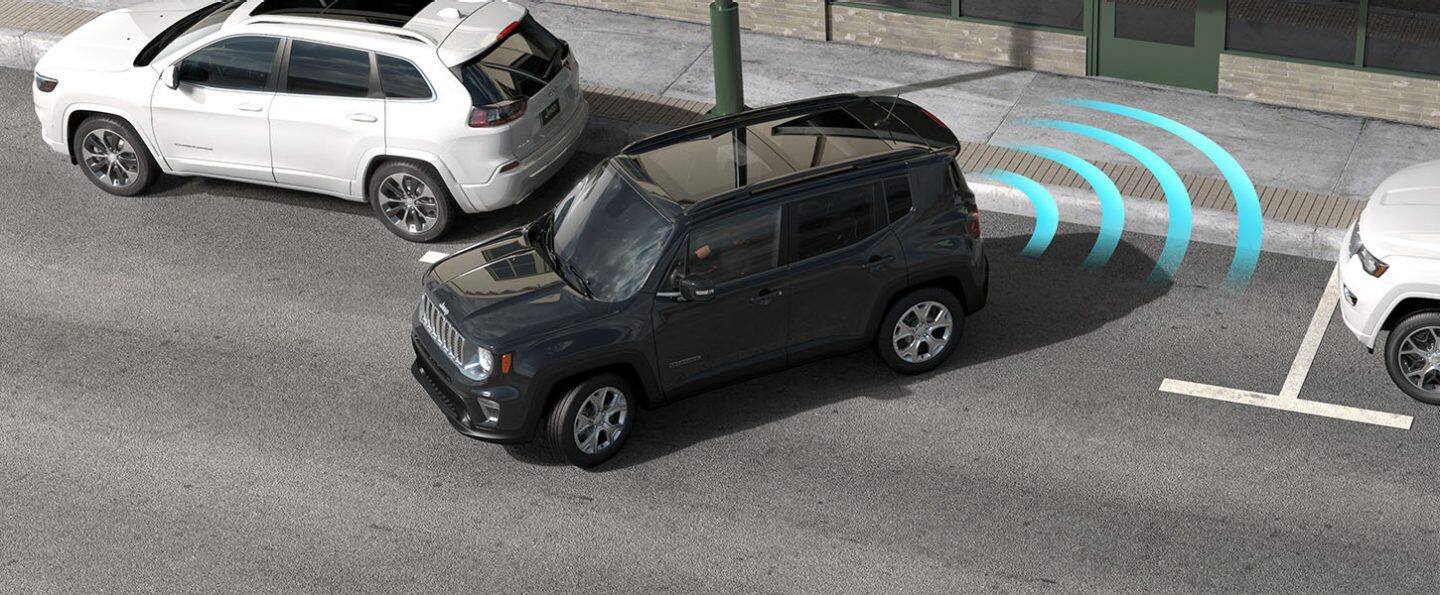 The 2022 Jeep Renegade backing into a parking spot at a curb, with illustrated sensor lines coming from its rear to detect any obstructions behind it.