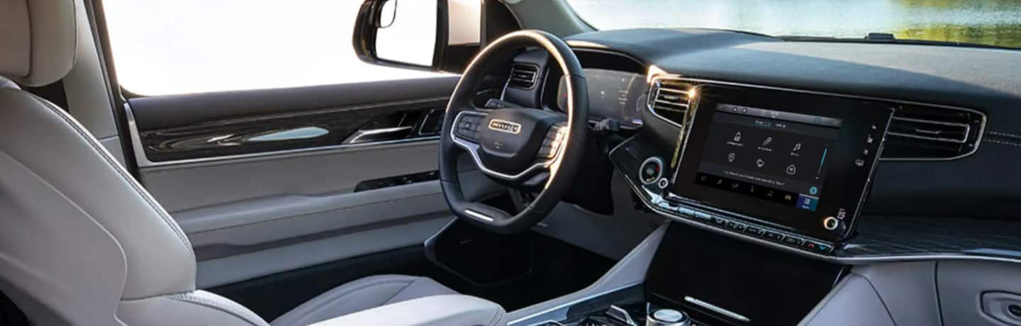 The driver seat, steering wheel, Uconnect 5 with 10.1-inch touchscreen and dash in the 2022 Wagoneer Series III.