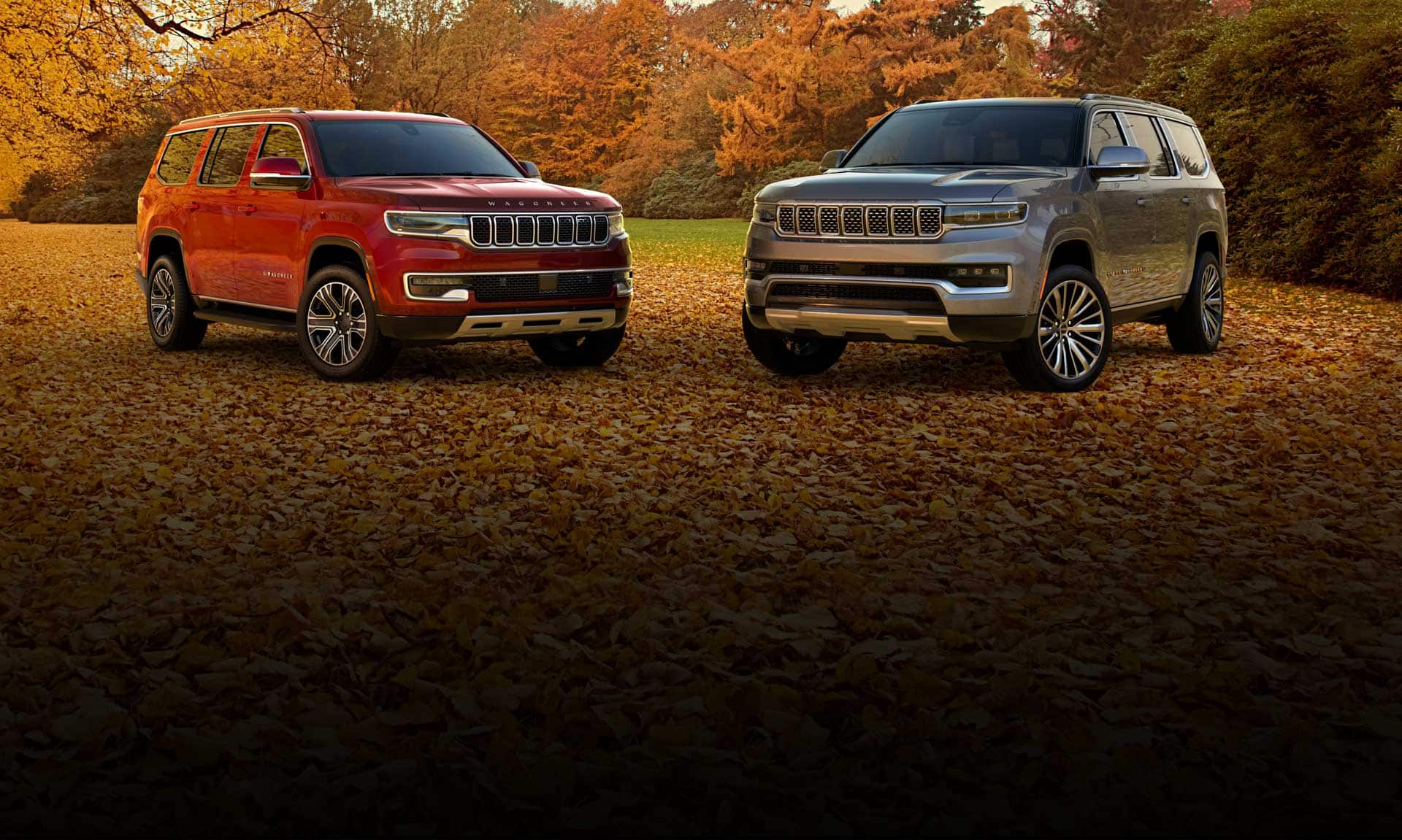 The 2022 Wagoneer Series 3 and Grand Wagoneer Series 3 parked in a field blanketed with autumn leaves.