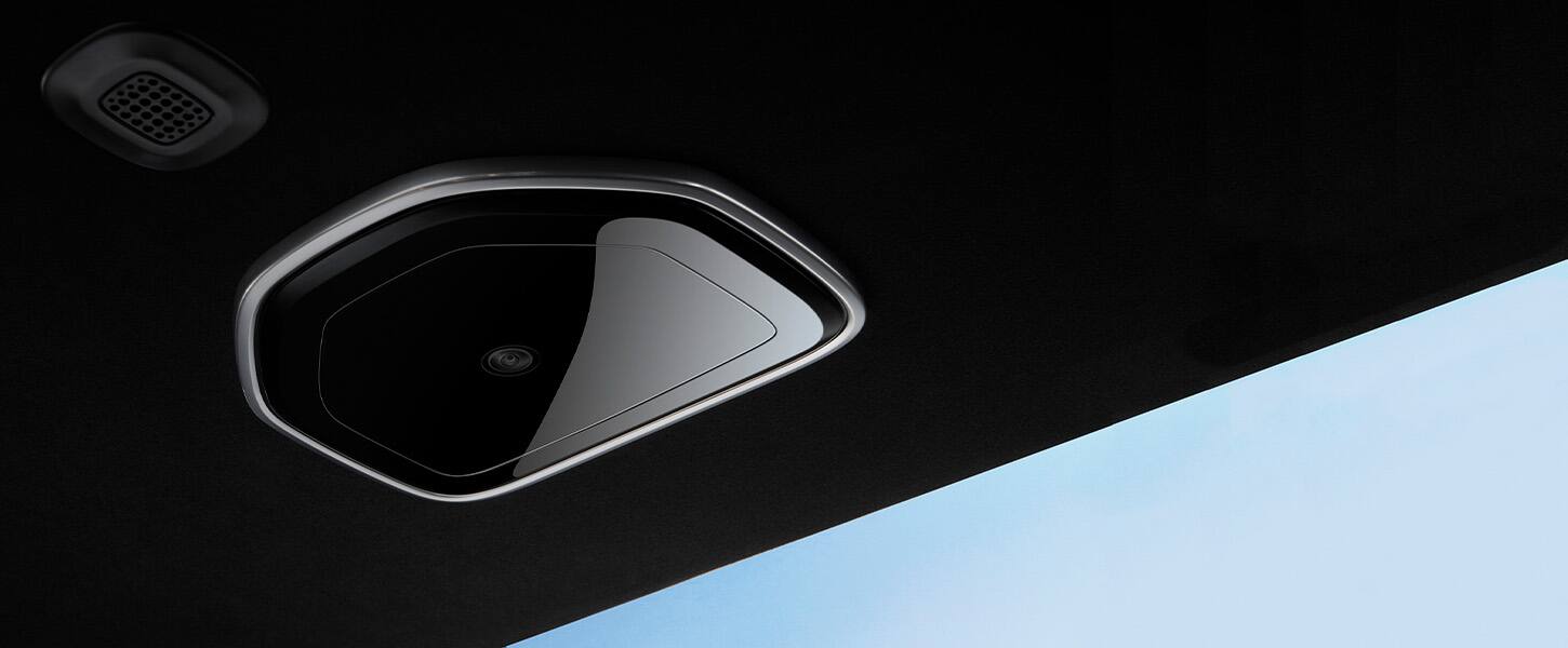 A close-up of the rear monitoring camera in the 2022 Grand Wagoneer, showing the location of the camera on the vehicle ceiling.