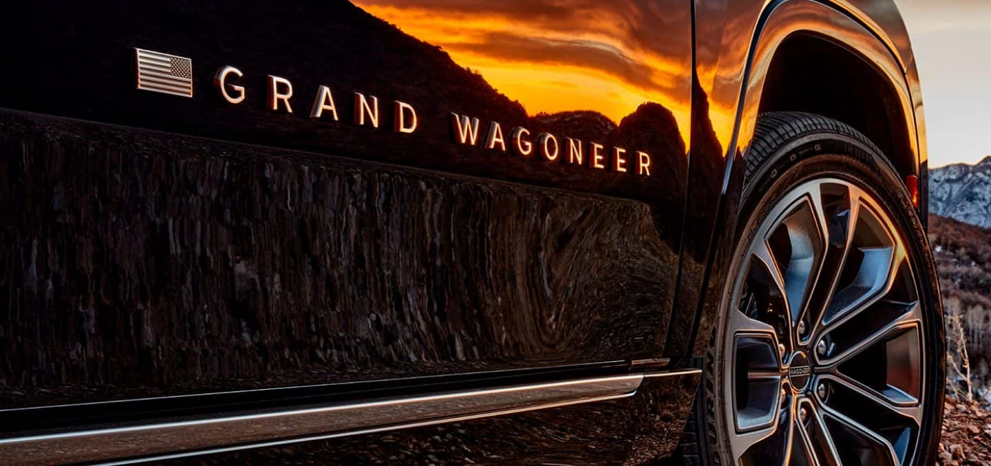 Display A close-up of the American flag Grand Wagoneer badge on the side of the 2022 Grand Wagoneer.