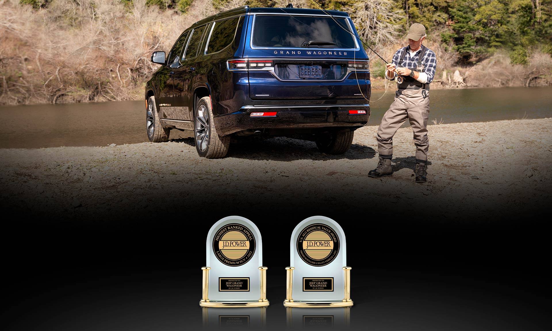 The rear view of a 2022 Grand Wagoneer Series III parked beside a lake with a man standing beside it, adjusting a fishing pole. Two J.D. Power Appeal trophies. One reads: Highest Ranked Appeal – Large Premium SUV 2022; Presented to Jeep Grand Wagoneer by J.D. Power. The other reads: Best AIG Residual Value Award – Large Premium SUV 2022; Presented to Jeep Grand Wagoneer by J.D.Power. 