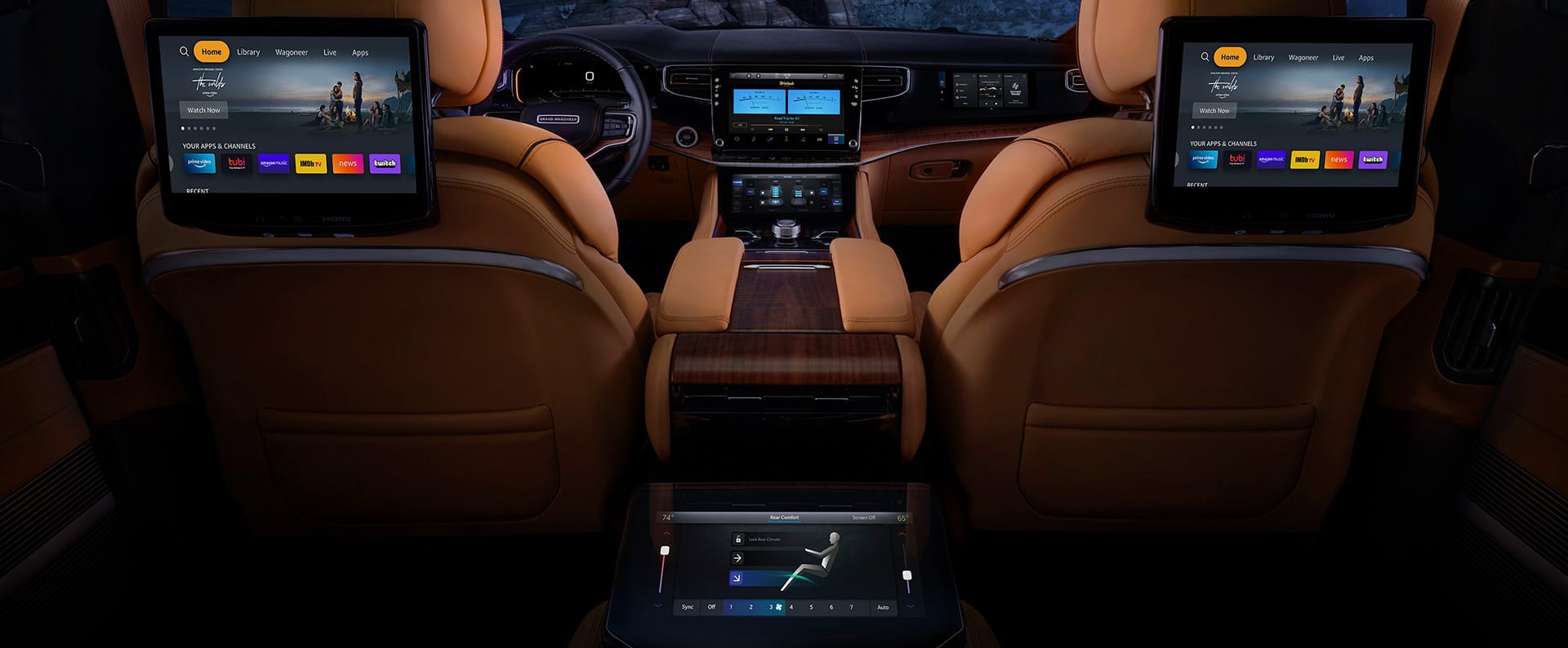 The interior of the 2022 Grand Wagoneer showing the second-row screens mounted on the back of the driver and front passenger seats.