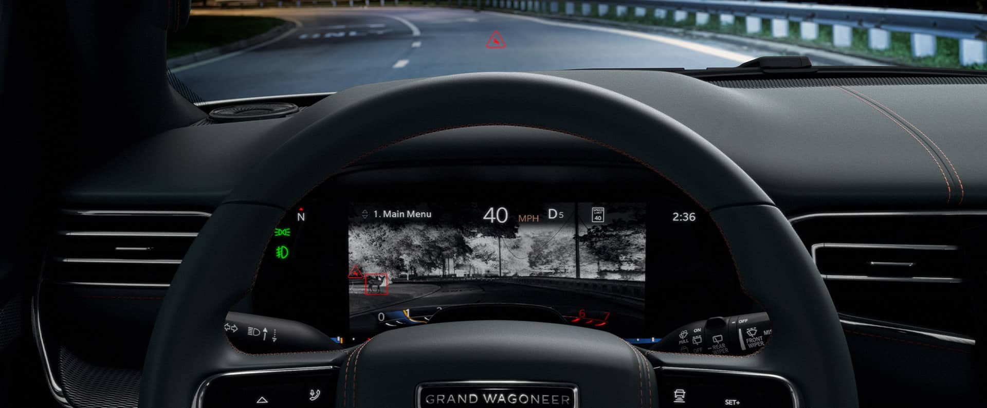 The Driver Information Digital Cluster display in the 2022 Grand Wagoneer showing the night vision camera view of the road ahead with a deer at the side of the road highlighted in red.